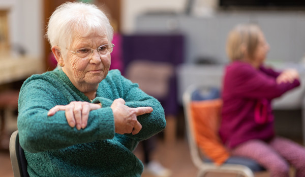 Older Woman Sitting Doing Chair Exercises