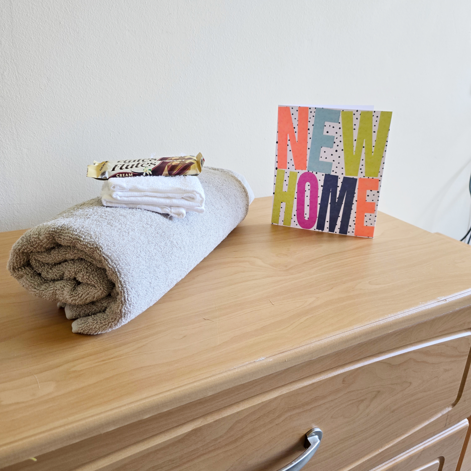 Side Cabinet With Towel, Chocolate And New Home Card At Downing House