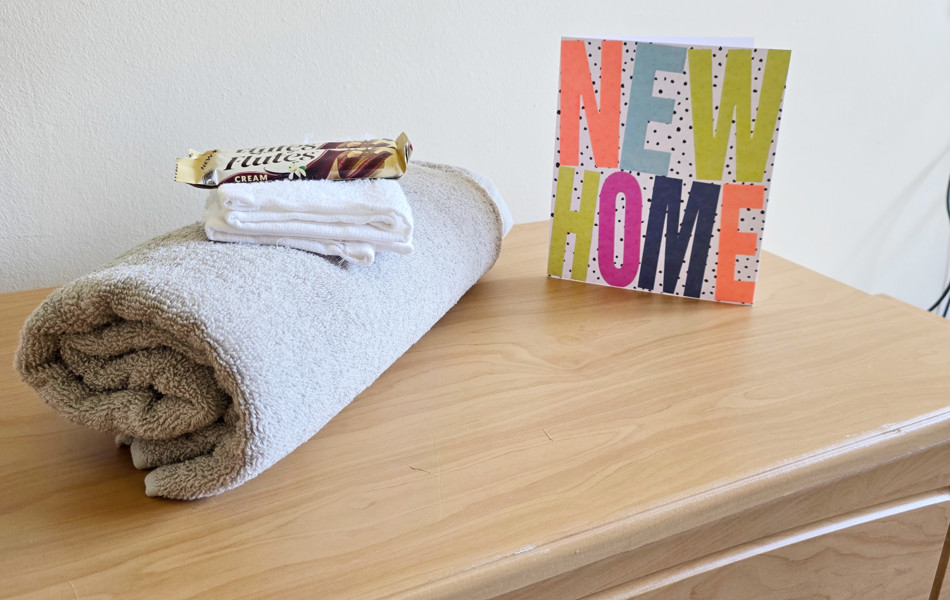 Side Cabinet With Towel, Chocolate And New Home Card At Downing House