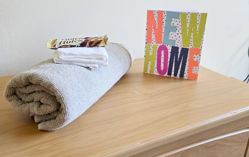Side Cabinet With Towel, Chocolate And New Home Card At Downing House