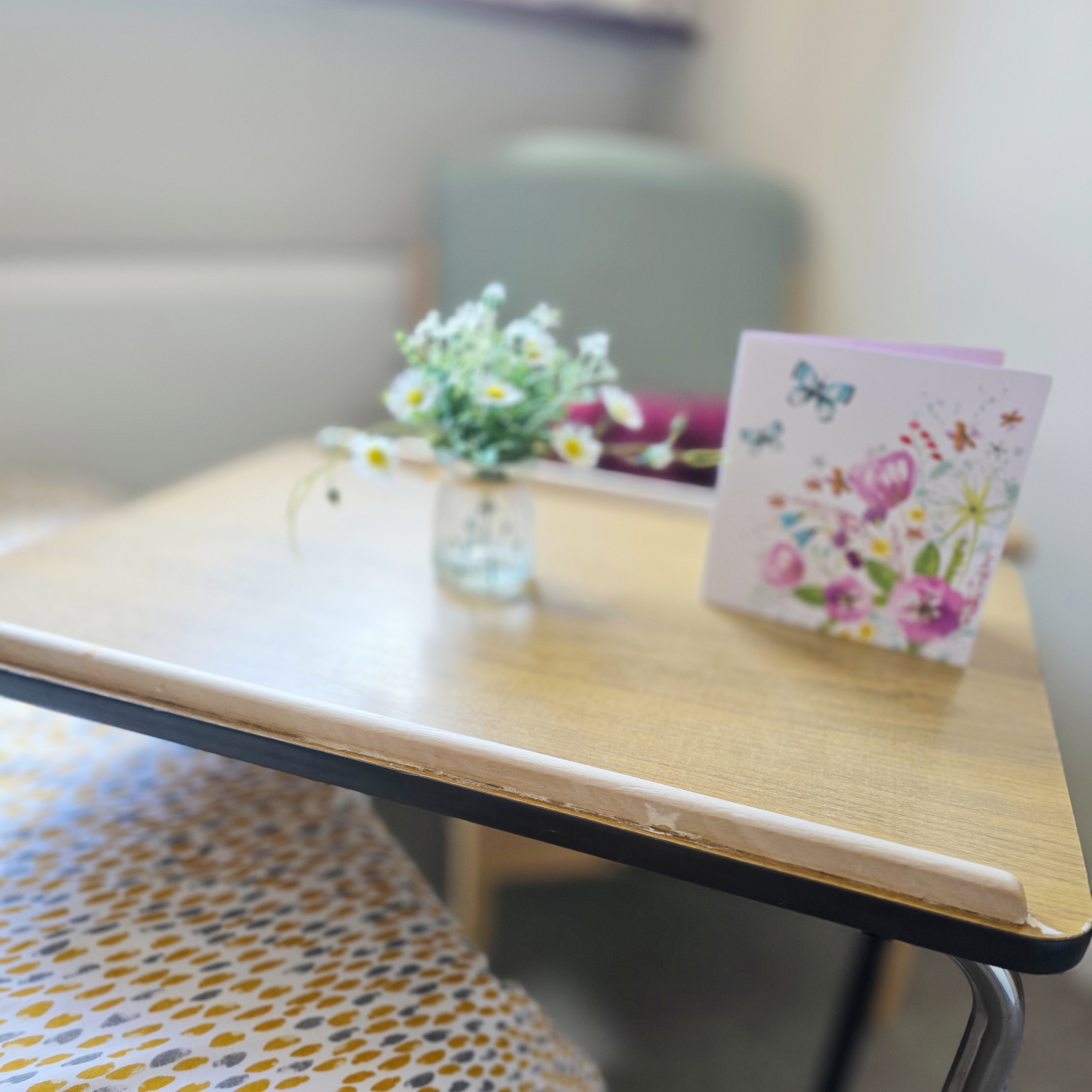 Card And Flowers On Over Bed Table In A Resident Room