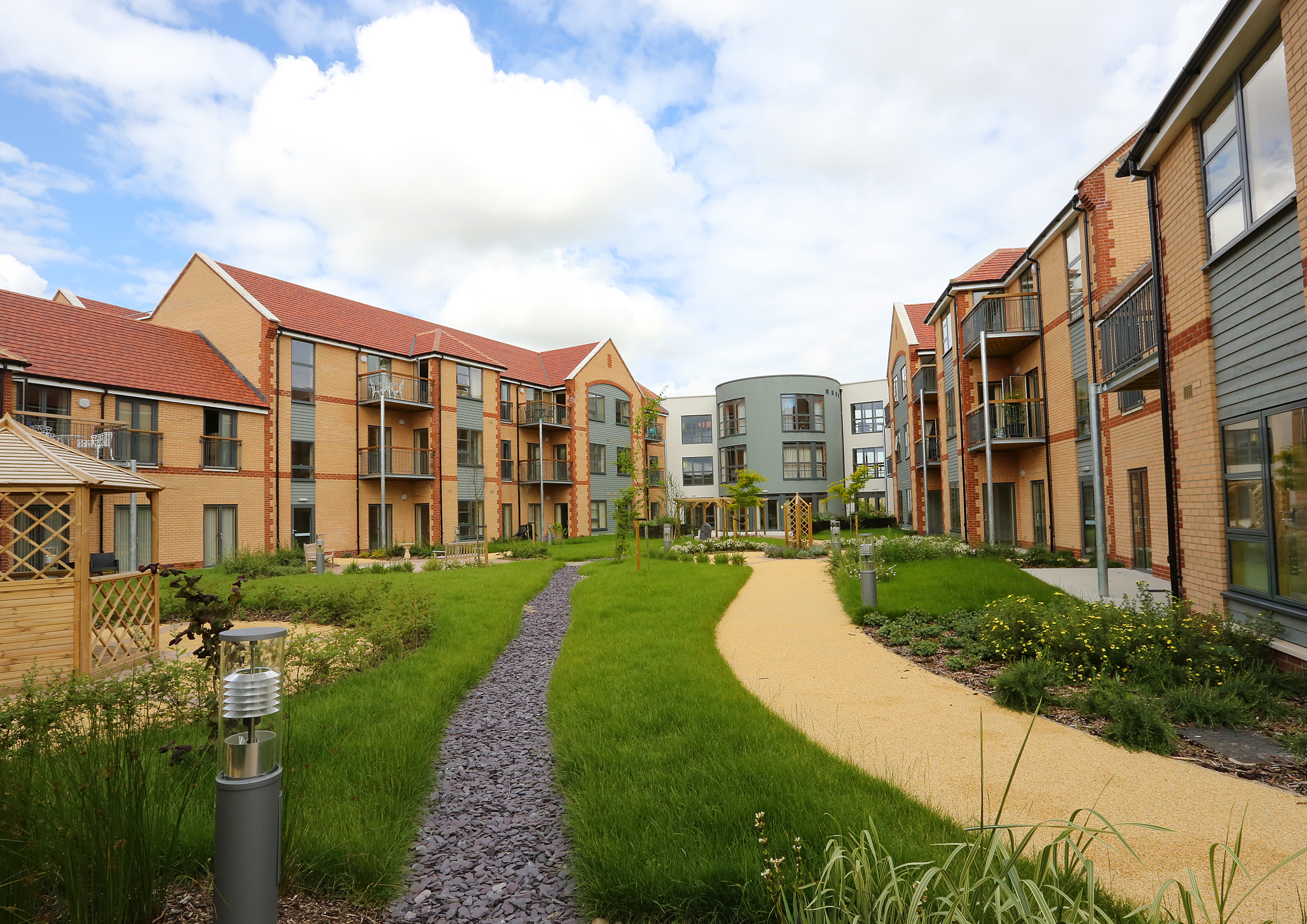 Exterior shot of Girton Green showing the ample, bright grounds where residents can enjoy the sunshine or a breath of fresh air