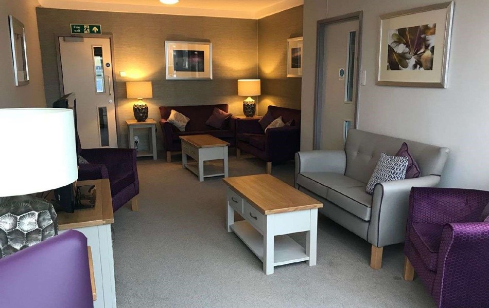 A modern lounge area with purple and grey chairs