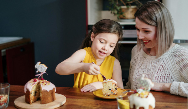 Mother And Daughter Enjoying A Slice Of Cake