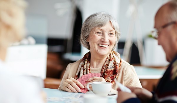 Residents Sitting Around A Table Playing Cards. Jpg