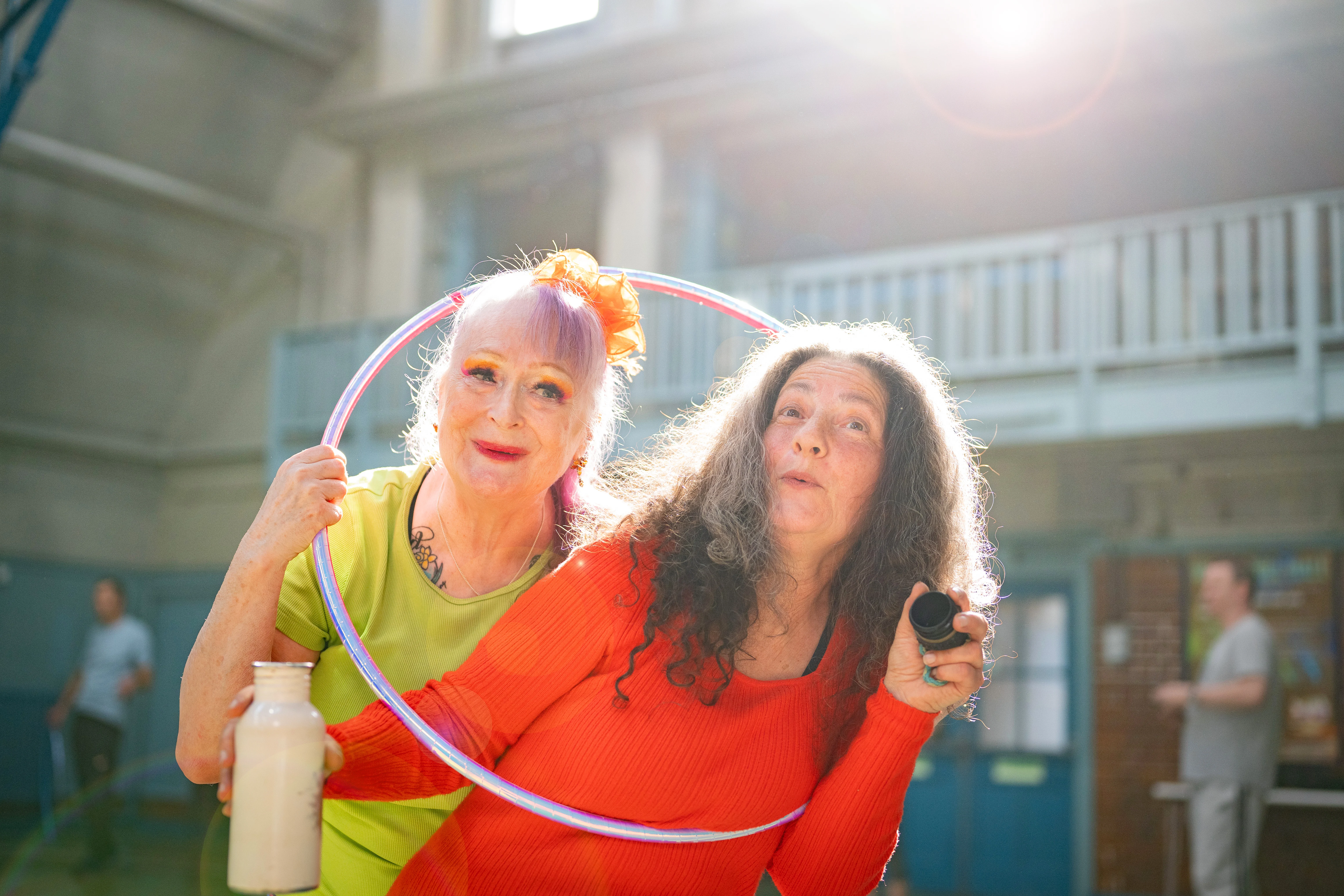Two Older Women Standing In A Hoop Together