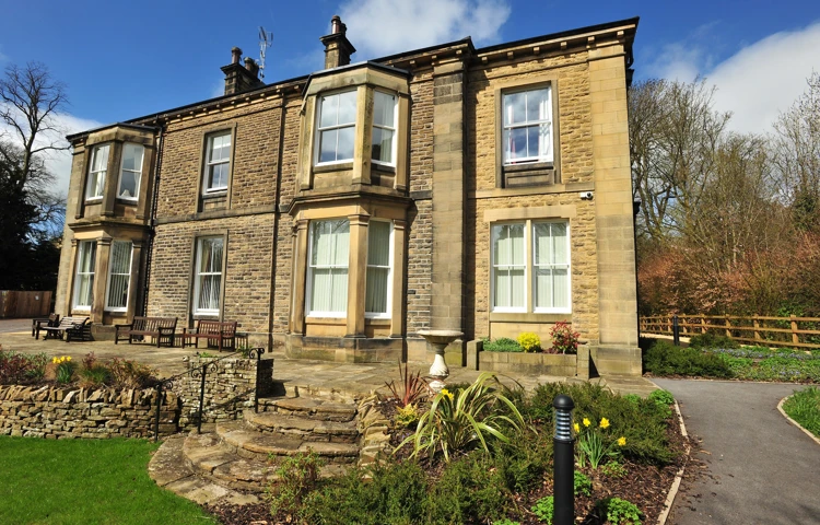 Full view of the house with stone steps into the garden
