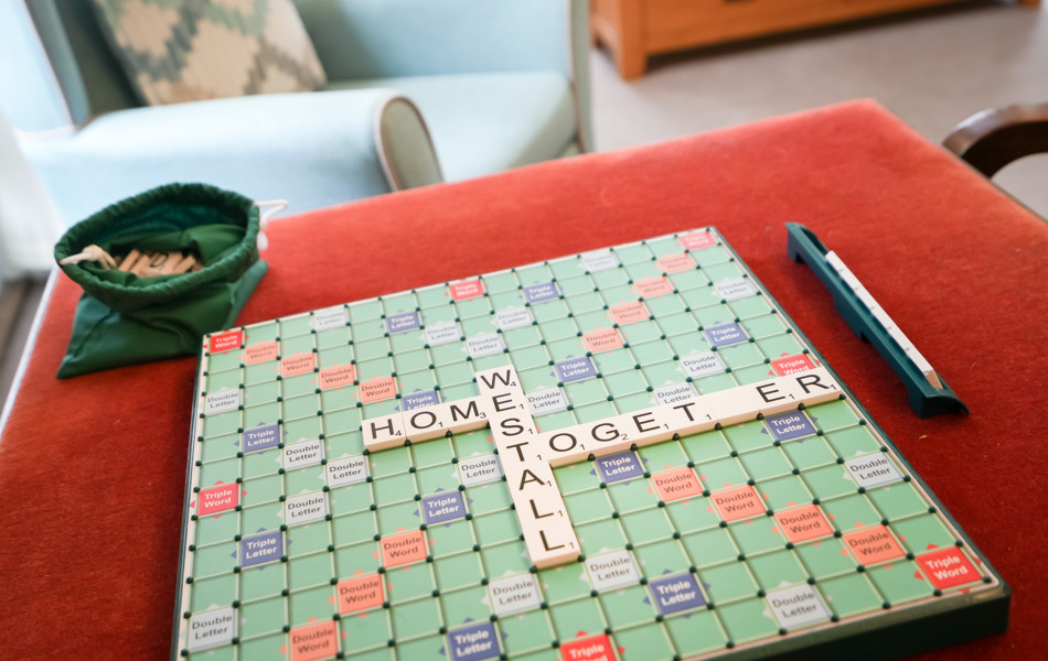 Enjoy a game of Scrabble in the communal area at Westall House Residential Care Home in Horsted Keynes.