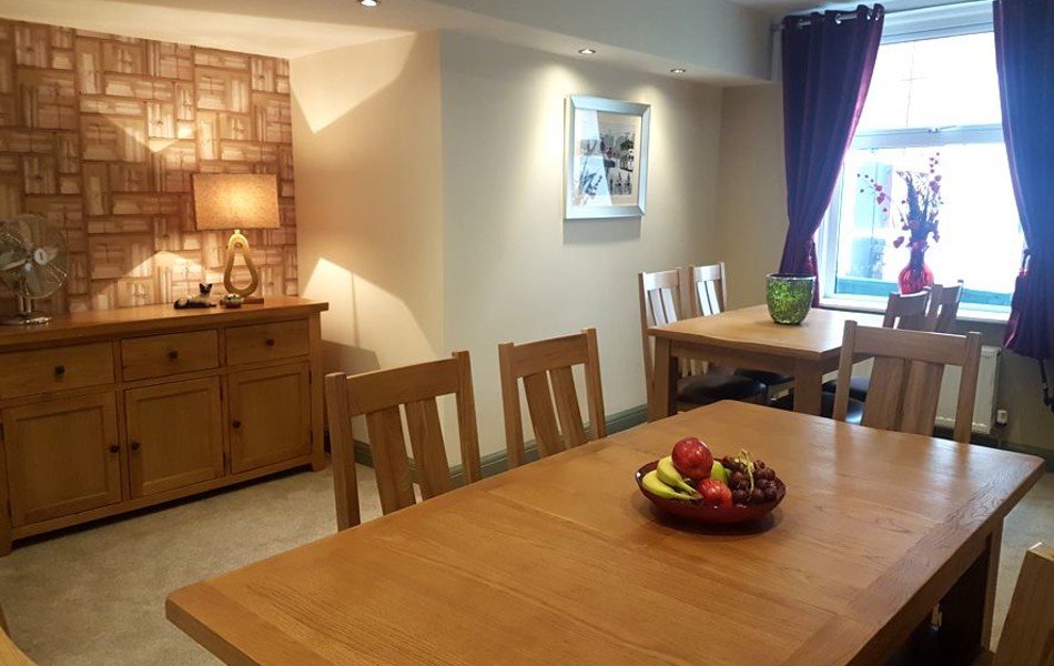Large dining table with a basket of fruit