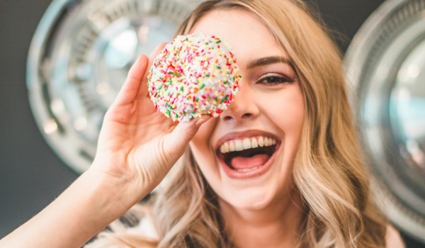 Woman Holding Up Doughnut Over Eye