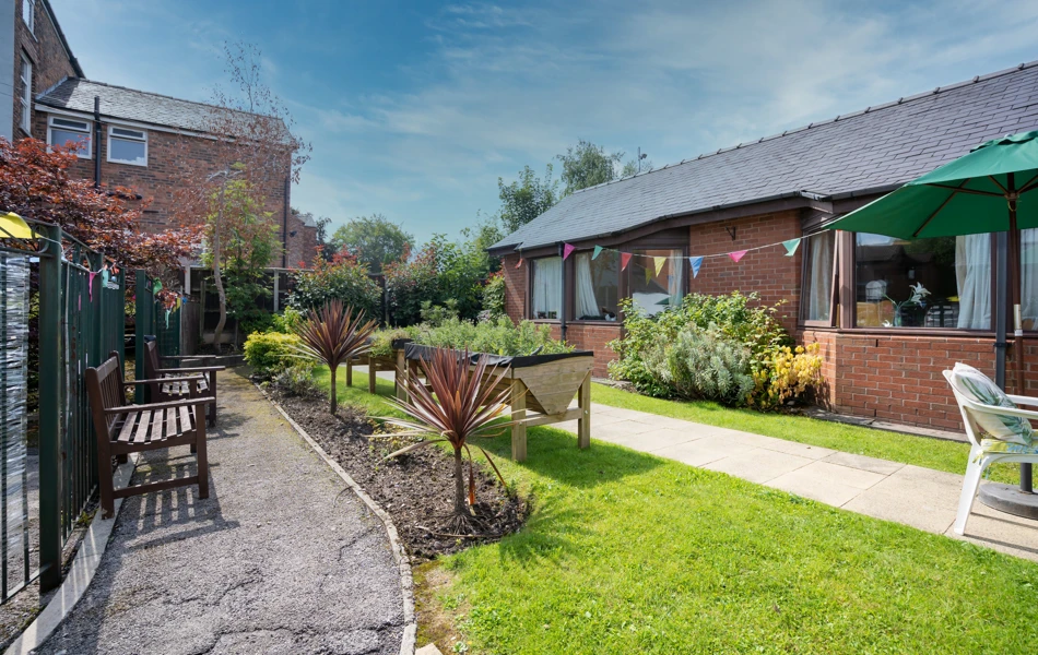 Downing House has seating area for residents to enjoy the garden.