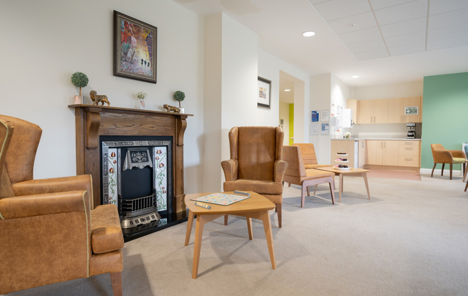 Lounge area with large fireplace to play games at Hope Bank View