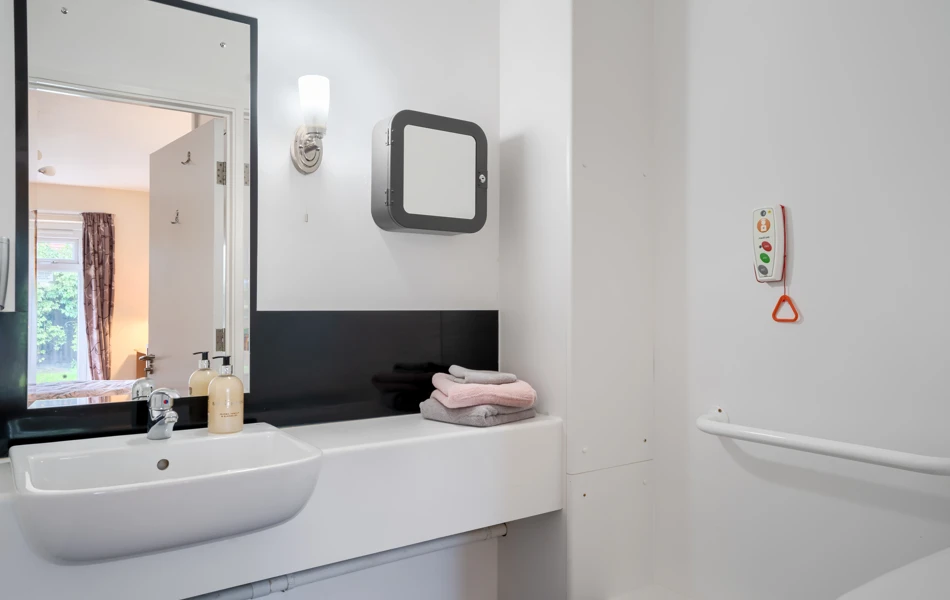 En-suite bathroom with mirror at Halcyon House Care and Nursing Home