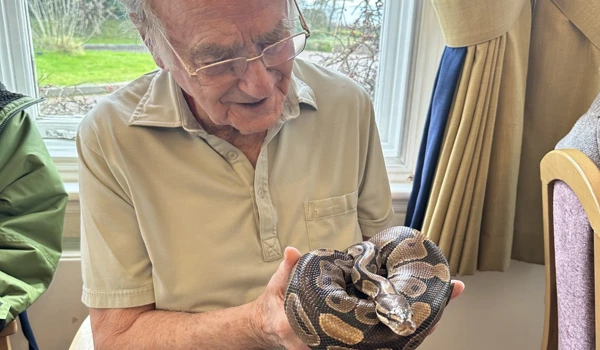 Resident From Hill House Holding A Snake