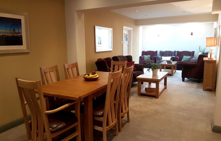 Lounge dining area with long table and chairs