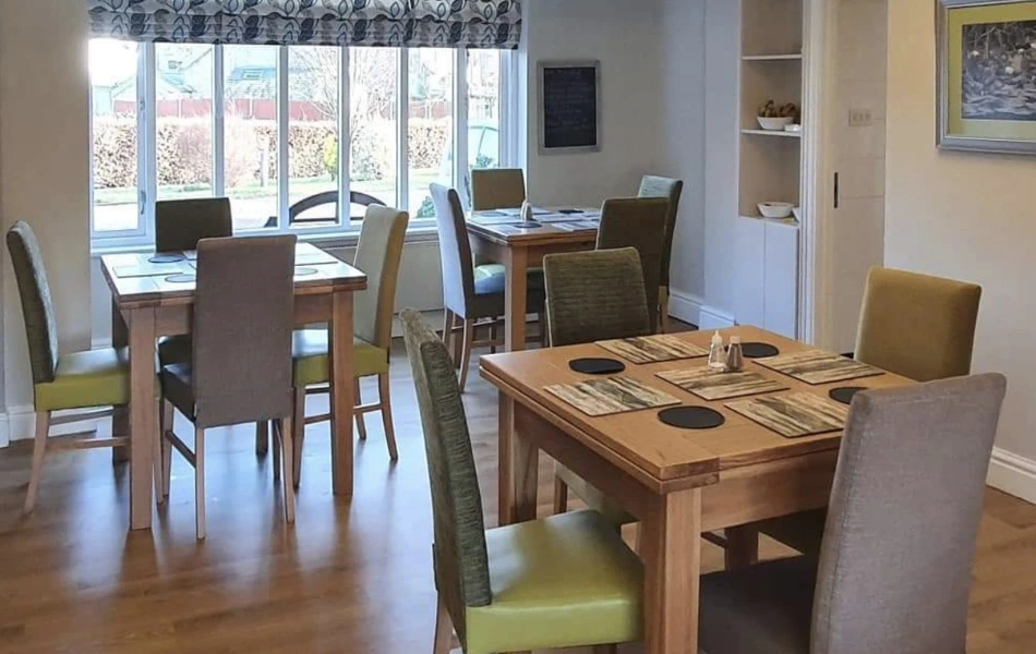 Dining tables and chairs in the interior of Abbeyfield House, Garstang PR3 1PA