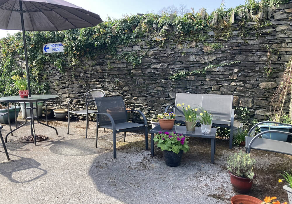 Relax and enjoy the gardens and sunshine at Abbeyfield Nine Oaks in Windermere, LA23 1BB