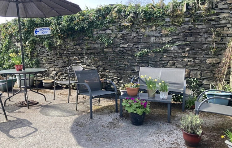 Relax and enjoy the gardens and sunshine at Abbeyfield Nine Oaks in Windermere, LA23 1BB