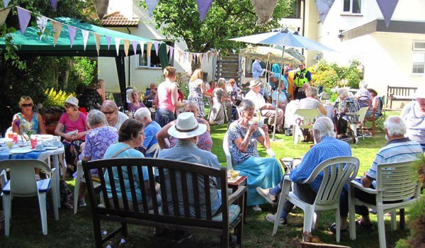 Residents, staff and families enjoying a garden party