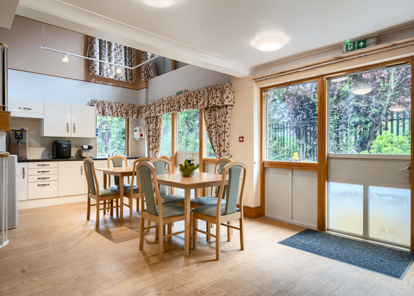Cafeteria with table and chairs at Abbeyfield House, New Malden