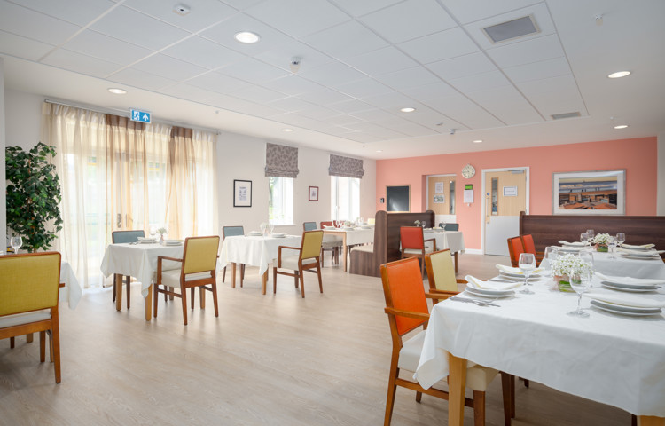 Large windows feature in resident dining room at Hope Bank View