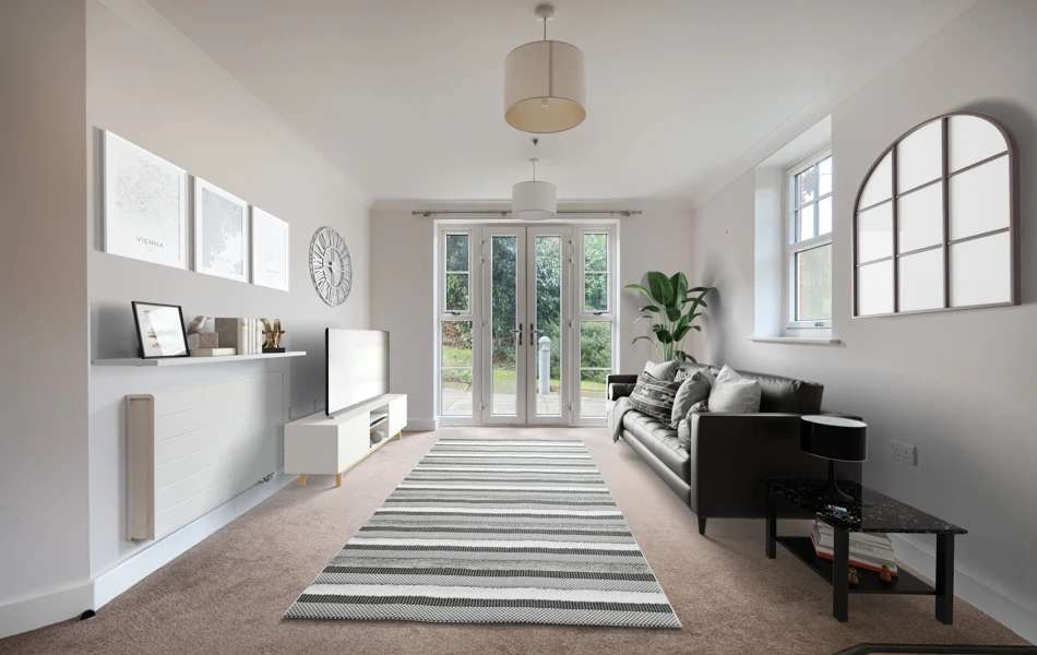 A tastefully decorated living room with patio doors to the garden