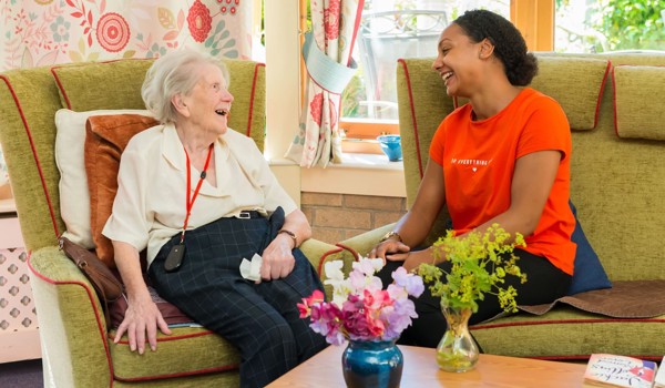 Older Woman With Staff Member