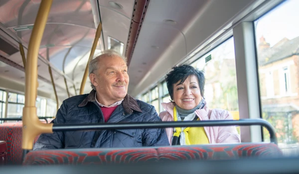 Older Couple Sitting On A Bus Together