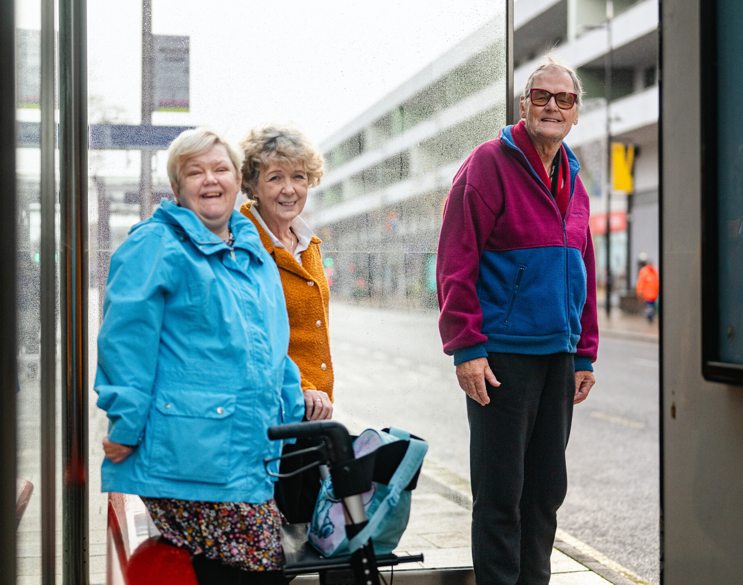Smiling Older People At A Bus Stop