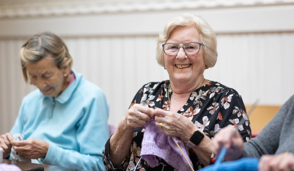 Group Of Happy Older Woman Doing Knitting Together