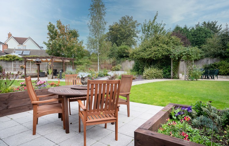 Garden patio area with tables and chairs at Hampton House Solihull