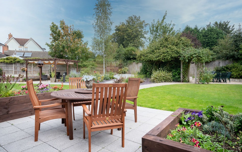 Garden patio area with tables and chairs at Hampton House Solihull