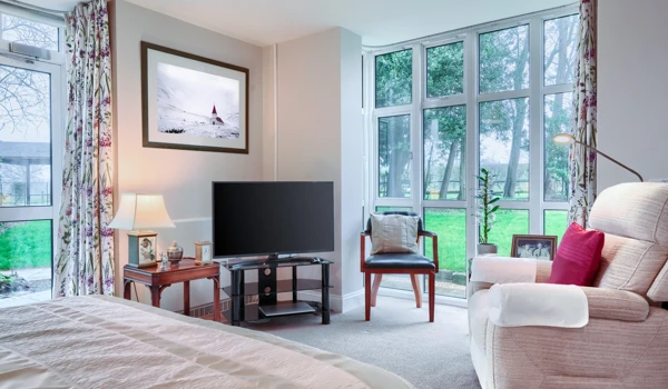 Comfortable armchair and television in a resident's room at Westall House Residential Care Home, Horsted Keynes, creating a relaxing and private space