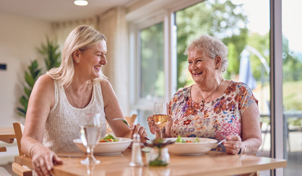 Two Women Sitting Together Enjoying Lunch