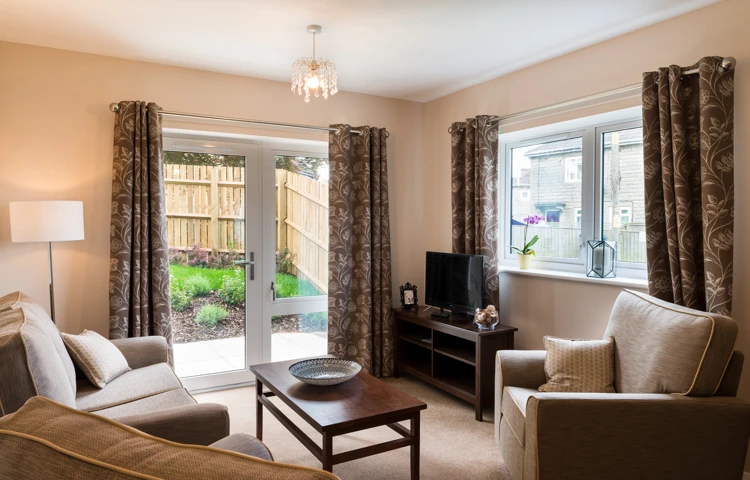 Living area with french doors out to the garden at Burnham Court