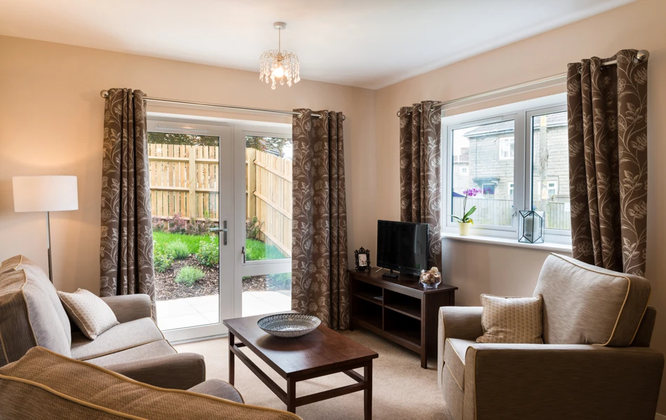 Living area with french doors out to the garden at Burnham Court