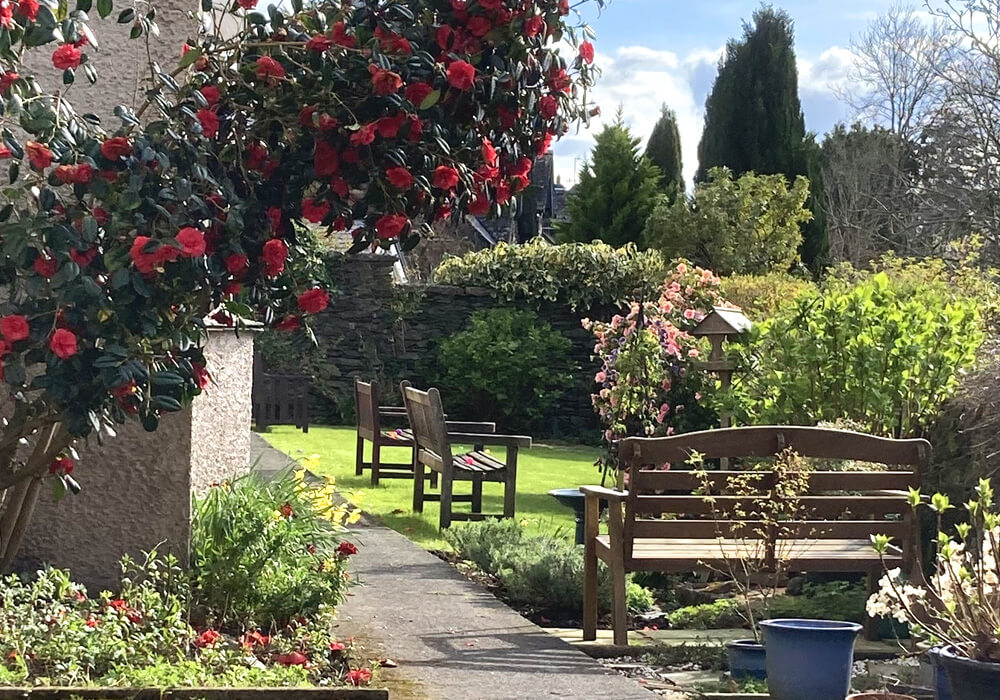 Welcoming Garden Seating Areas in full bloom at Abbeyfield Nine Oaks in Windermere, LA23 1BB