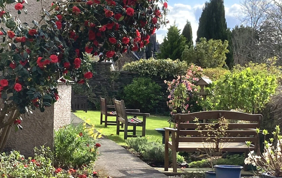 Welcoming Garden Seating Areas in full bloom at Abbeyfield Nine Oaks in Windermere, LA23 1BB