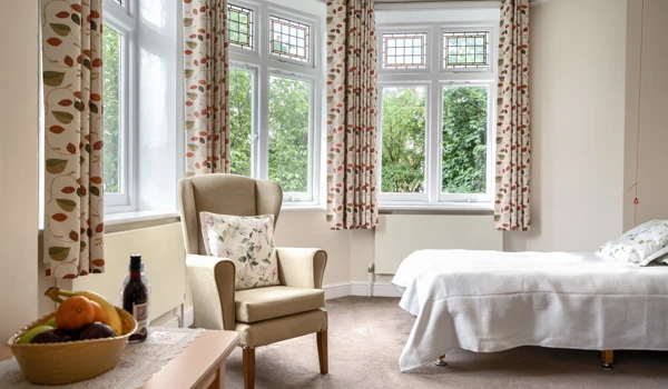 Bedroom with garden view through bay windows at Lee House Wimbledon