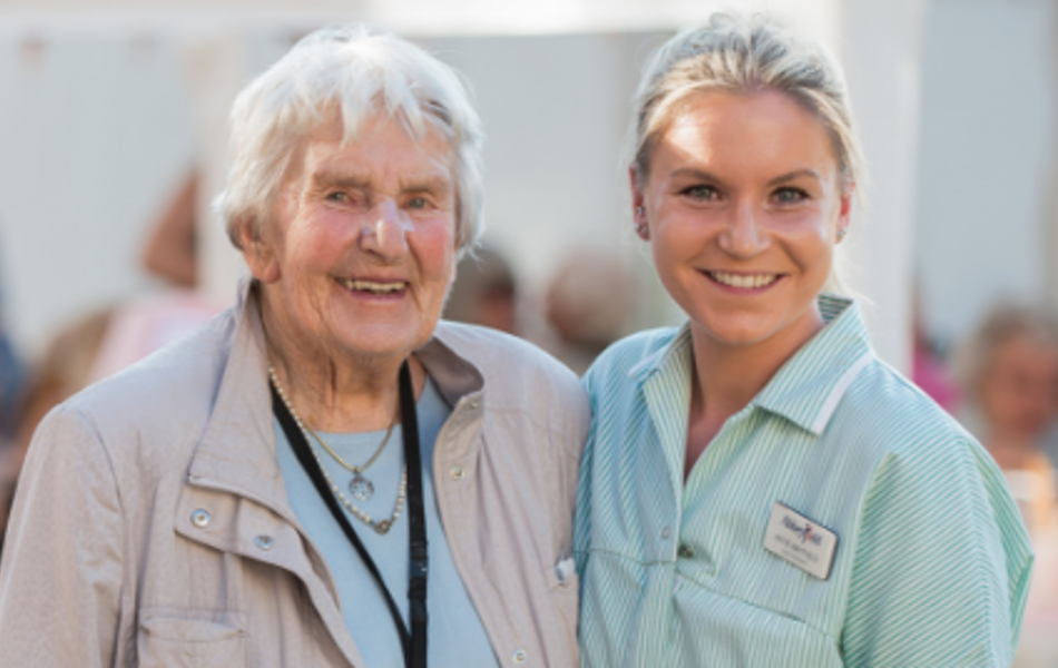Smiling resident and staff member at Westall House event