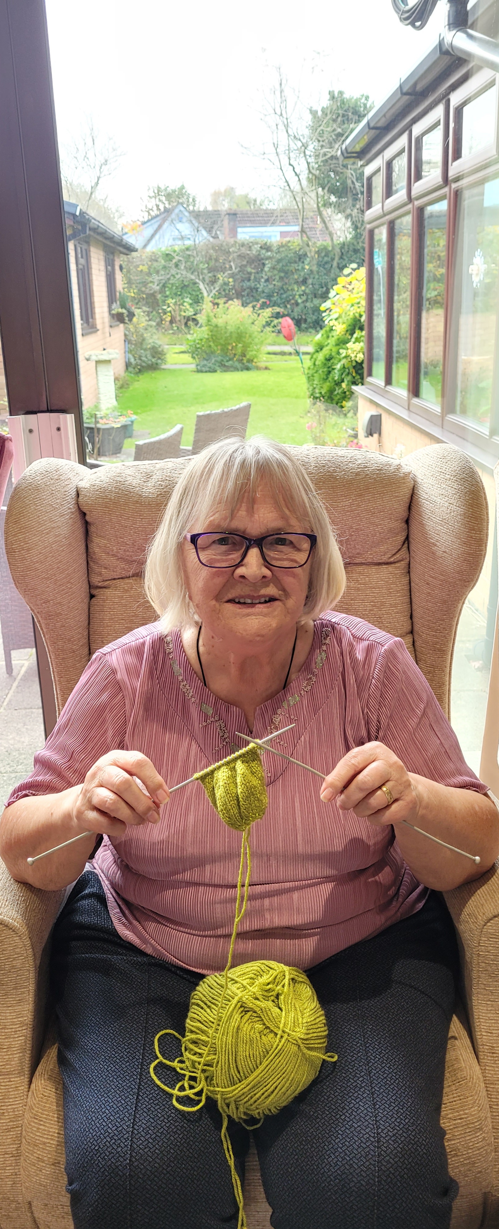 June Sitting In Chair And Knitting