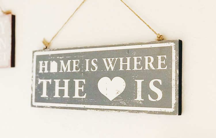 Sign on the wall saying Home is the where the heart is