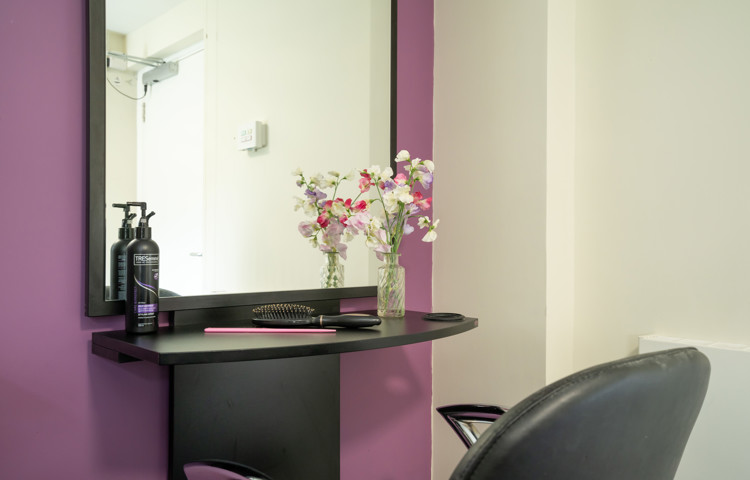 Pratt House hair salon with purple and grey decor