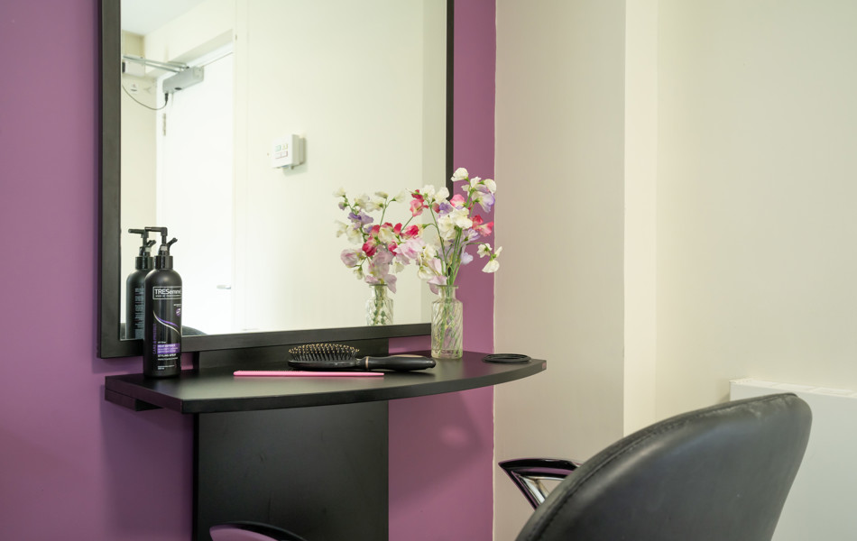 Pratt House hair salon with purple and grey decor