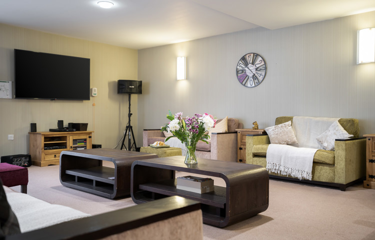 Communal resident lounge seating and tables at Hampton House